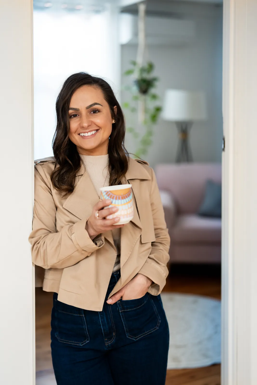 Ellie O'Halloran standing in the doorway of her Albury counselling room, holding a mug